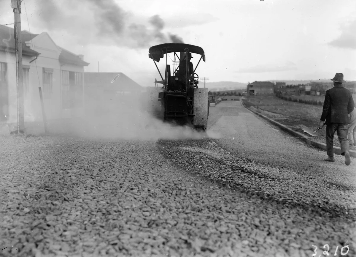 Steamroller spraying tar in Mort Street, Canberra City.