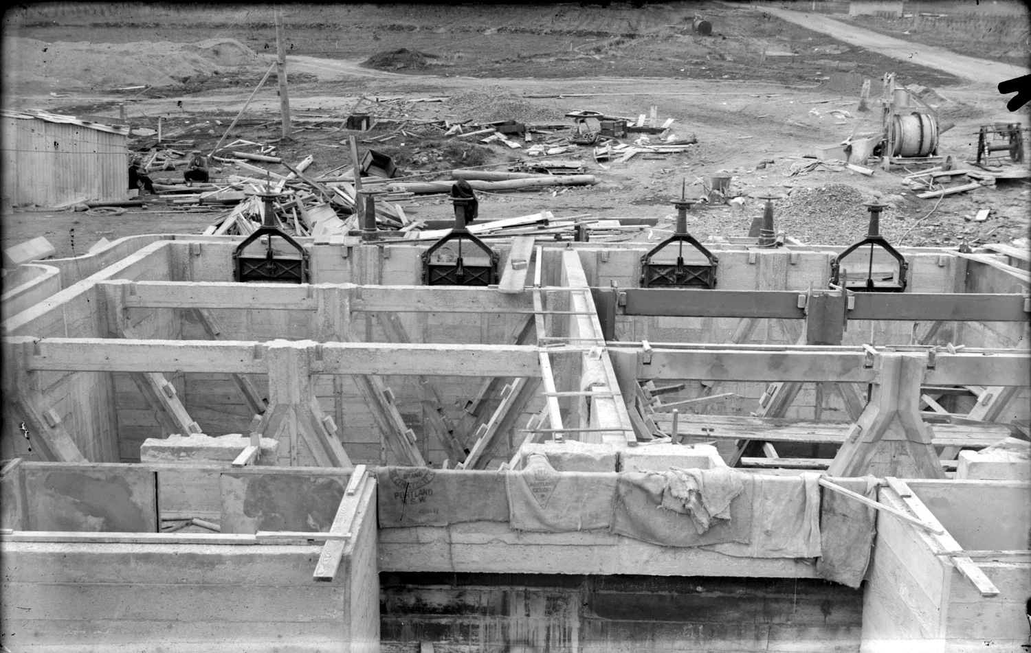 Concrete tanks, timber formwork, valves and equipment at the Weston Creek sewerage treatment works under construction.